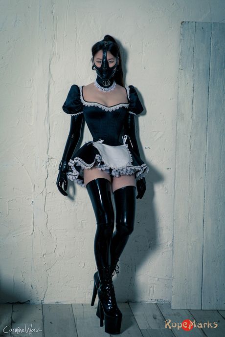 Asian maid in latex uniform strips and shows her big booty and tits